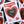 A heart-shaped enamel pin reading 'Creamy Pints' is displayed on a white card with red and pink graphics. The card is surrounded by other similar cards showing different pins, arranged on a black gridded surface.